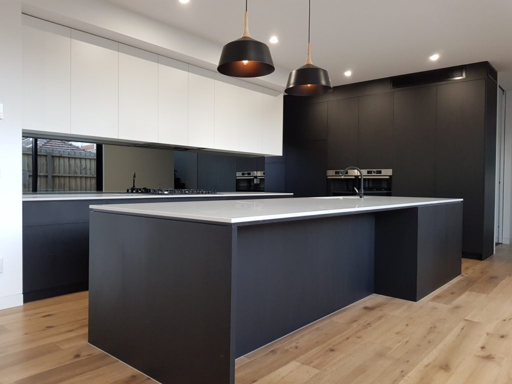 Modern kitchen with timber floors in Caulfield.