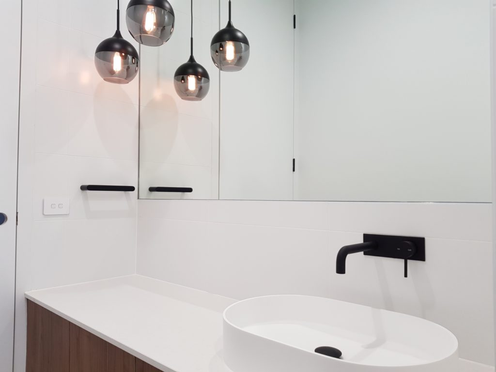 Elegant vanity in bathroom, with lighting.