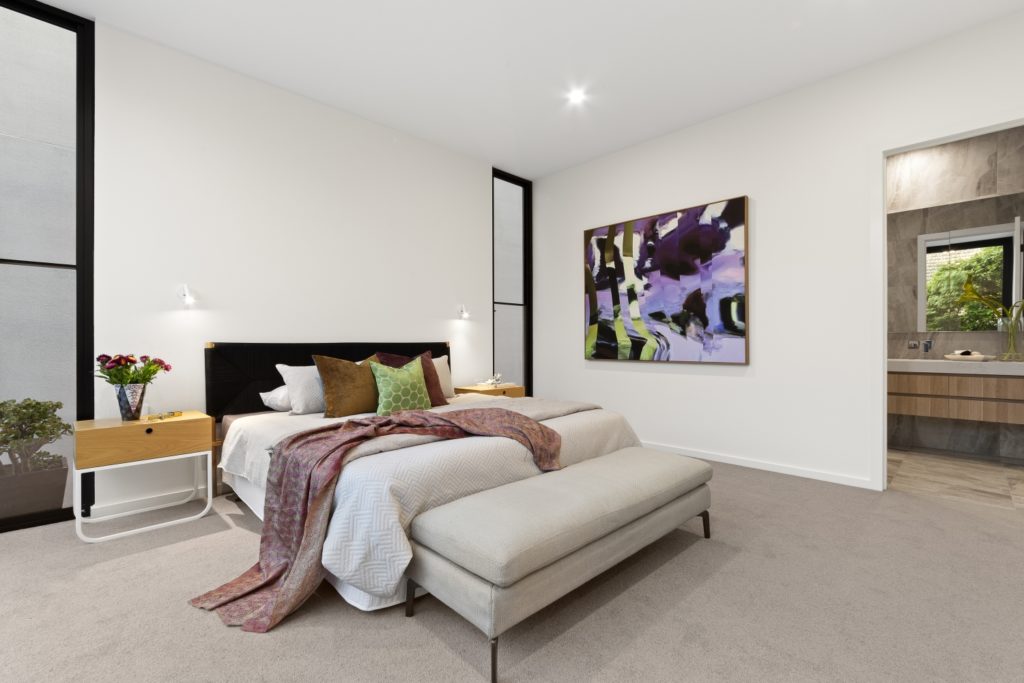 Carpeted, Caulfield bedroom with modern design.