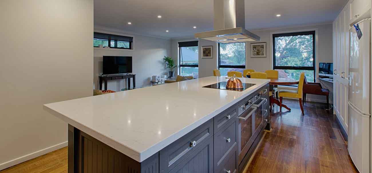 Marble top kitchen island with canopy rangehood in Ferntree Gully.