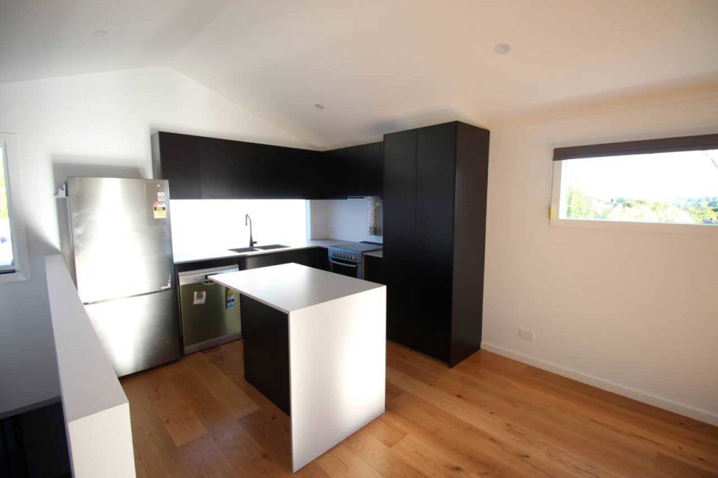 Modern second storey kitchen with island by Mass Constrictions. Located in Glen Iris.