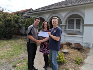 Home owner paying cheque to builder.