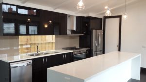 Modern kitchen with black cabinet.